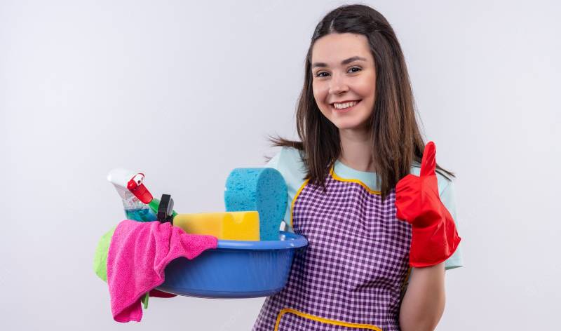 Woman in red gloves with tools and supplies in hand