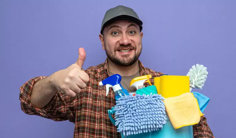 young man with some cleaning supplies ready for cleaning