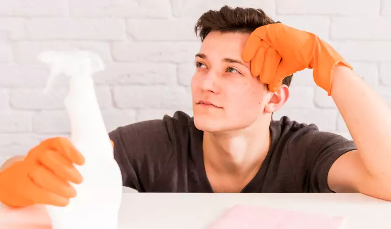 young man thinking about something and ready to clean his house
