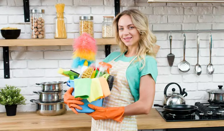 young woman inside of a house with some cleaning supplies