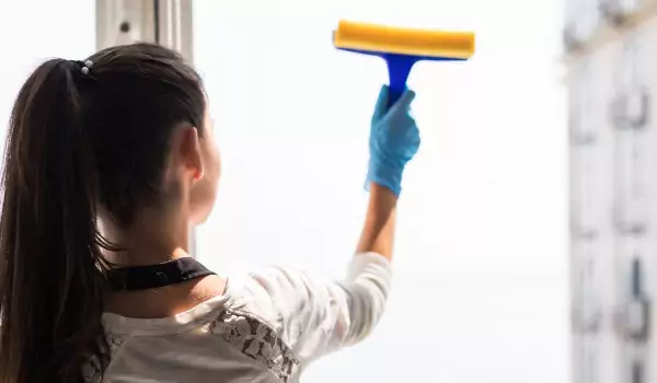 woman cleaning the window glass