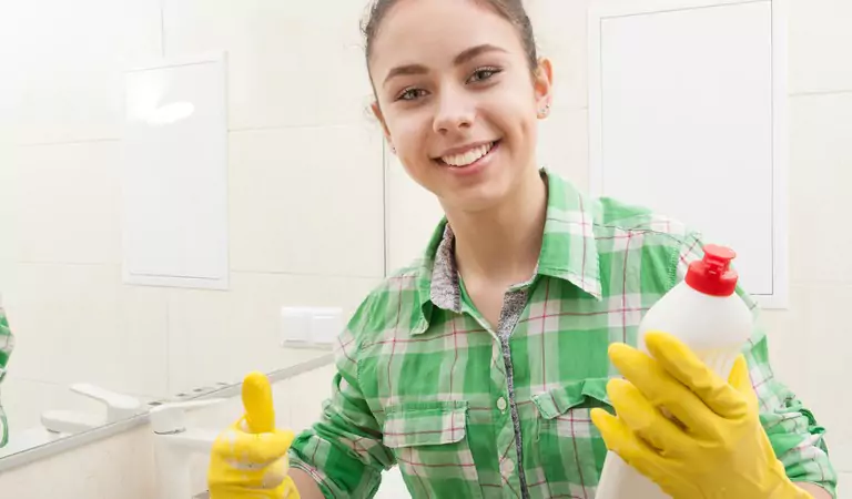 woman with a cleaning product ready to clean