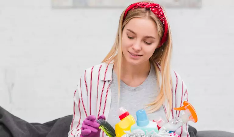 woman with some cleaning supplies ready to clean