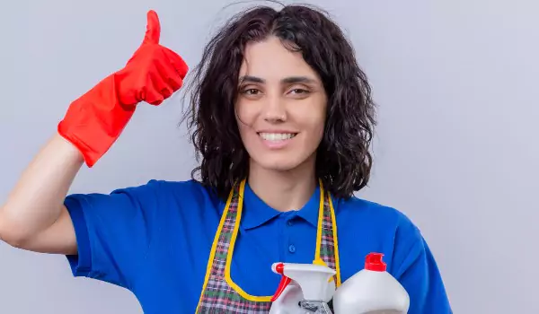 woman with cleaning essentials ready to clean