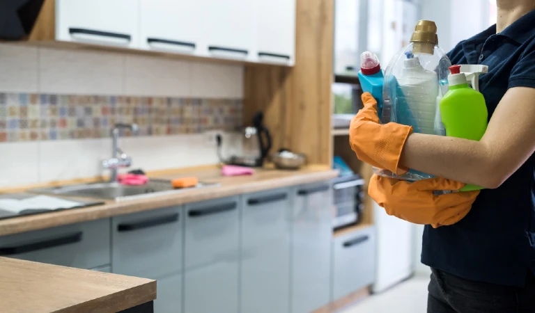 Woman holding cleaning products and products and ready to clean
