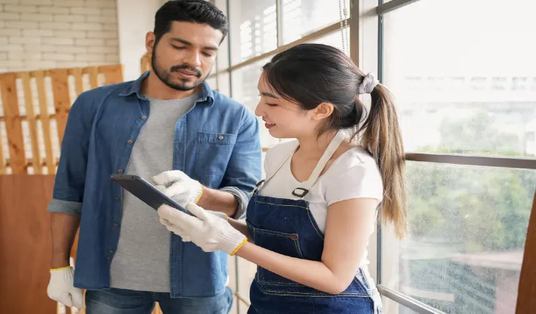 Young man and woman looking at the screen of a tablet