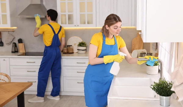 Professional janitors working in kitchen cleaning service