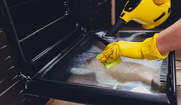 Steam cleaning oven house cleaning hand close-up