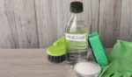 Natural cleaning products vinegar in bottle baking soda glove sponge and brush